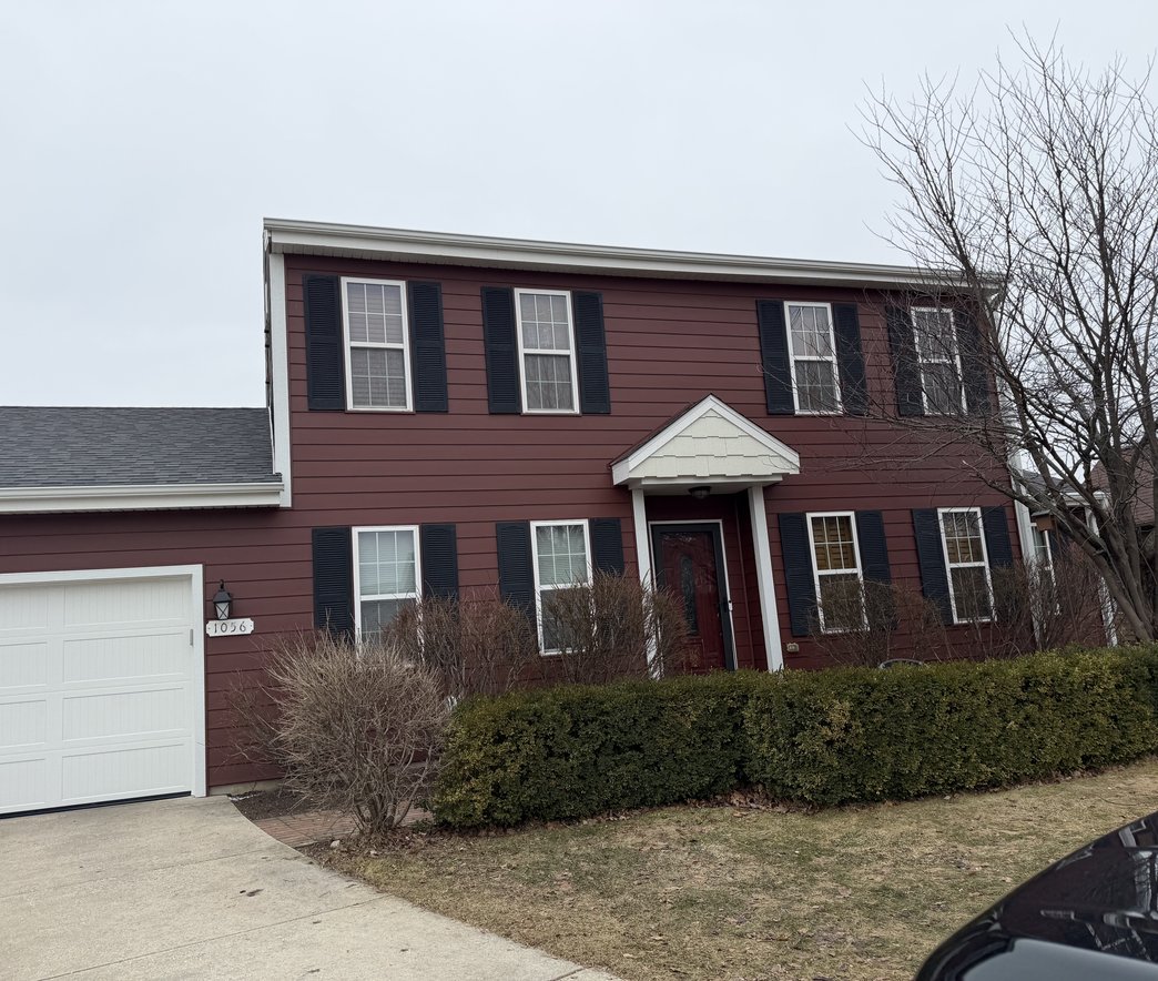 Roofer replacing shingles on a roof